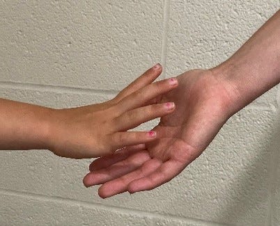 Holding the hand of a child