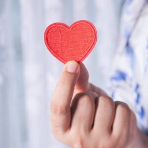 Person holding a paper heart